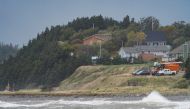 Waves crash ashore as vehicles watch during the arrival of Hurricane Fiona in Stephenville, Newfoundland, Canada, on September 24, 2022. REUTERS/John Morris
