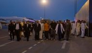 Prisoners of war (five British citizens, one Moroccan, one Swede, one Croat, and two Americans) are seen in the tarmac after arriving, following successful mediation efforts by Saudi Arabia's Crown Prince Mohammed bin Salman, from Russia to King Khalid International Airport, in Riyadh, Saudi Arabia, on September 21, 2022.