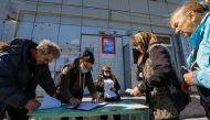 Local residents wait before receiving ballots from members of an electoral commission and casting their votes into a mobile ballot box on the third day of a referendum on the joining of the self-proclaimed Donetsk People's Republic (DPR) to Russia, in Mariupol, Ukraine on September 25, 2022. REUTERS/Alexander Ermochenko