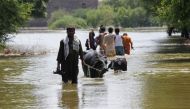 A man pulls his animals while others go to salvage their belongings amid rising flood water, following rains and floods during the monsoon season on the outskirts of Bhan Syedabad, Pakistan, on September 8, 2022.  File Photo / Reuters
