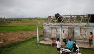 A family speaks in front of their destroyed home in the aftermath of Hurricane Ian in El Cafetal, Cuba, on September 27, 2022. REUTERS/Alexandre Meneghini