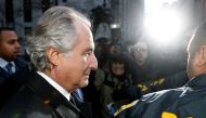 Disgraced financier Bernard Madoff is escorted by police and photographed by the media as he departs US Federal Court after a hearing in New York on January 5, 2009. File Photo / Reuters
