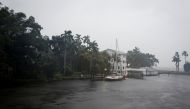 :A sailboat is seen moored at a house ahead of Hurricane Ian, in Fort Myers, Florida, on September 28, 2022. REUTERS/Marco Bello