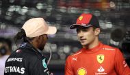 Ferrari's Charles Leclerc celebrates after qualifying in pole position with Mercedes' Lewis Hamilton at the Singapore Grand Prix in Marina Bay Street Circuit, Singapore, on October 1, 2022. REUTERS/Edgar Su