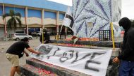 Arema football club supporters put a banner on a monument outside the Kanjuruhan stadium to pay condolence to the victims in Malang, East Java province, Indonesia, October 2, 2022. Reuters/Willy Kurniawan