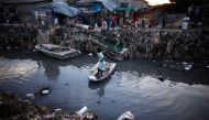 File Photo: A resident crosses a drain, which leads into the sea at downtown Port-au-Prince, Haiti. (Reuters/Eduardo Muñoz) 