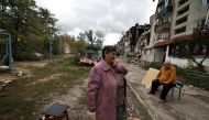 A woman reacts as she stands outside a building that was damaged by a Russian missile amid Russia's attack on Ukraine, in Svyatohirsk, in Donetsk region, Ukraine, on October 3, 2022. (REUTERS/Zohra Bensemra)