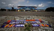 Flowers and supporters' tributes are placed to pay condolences to the victims of a riot and stampede following soccer match between Arema vs Persebaya, outside Kanjuruhan stadium in Malang, East Java province, Indonesia, October 4, 2022. REUTERS/Willy Kurniawan