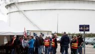 Workers on strike gather in front of the ExxonMobil oil refinery in Port-Jerome-sur-Seine, France, on October 5, 2022. REUTERS/Benoit Tessier