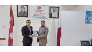 Prof Mohammed Ramzan Ali Miya presenting a copy of Maile Dekheko Qatar to Laxuman Khanal, Deputy Chief of Mission of the Nepal Embassy in Qatar.