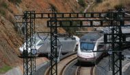 A passenger train passes by a wrecked train engine at the site of a train crash in Santiago de Compostela, northwestern Spain, July 26, 2013. Reuters/Miguel Vidal/File Photo