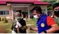 Officials and authorities guard the gate of daycare centre as people wait, after a mass shooting, in Uthai Sawan, Nong Bua Lamphu Province, Thailand in this screengrab taken from video on October 6, 2022. TPBS/Reuters
