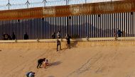 File Photo: Asylum-seeking migrants, mostly from Venezuela, walk out of the Rio Bravo river after crossing it to turn themselves in to US Border Patrol agents. (REUTERS/Jose Luis Gonzalez)