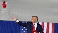 Former US president Donald Trump tosses caps to the crowd during a rally ahead of the midterm elections, in Minden, Nevada, US, on October 8, 2022. REUTERS/Carlos Barria