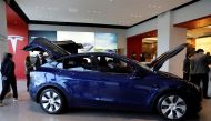 File Photo: Visitors wearing face masks check a China-made Tesla Model Y sport utility vehicle (SUV) at the electric vehicle maker's showroom in Beijing, China, January 5, 2021. (REUTERS/Tingshu Wang)