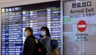Foreign travellers walk upon their arrival at the Haneda International Airport, on the first day Japan opened its doors to tourists after closing them for two-and-a-half years due to travel restrictions sparked by the outbreak of the coronavirus disease (COVID-19) pandemic, in Tokyo, Japan October 11, 2022. REUTERS/Issei Kato