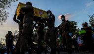 Police officers carry the casket of a victim on the day of a cremation at Wat Rat Samakee temple, following a mass shooting at a day care centre, in the town of Uthai Sawan, in the province of Nong Bua Lam Phu, Thailand, on October 11, 2022. REUTERS/Athit Perawongmetha