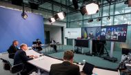 Ukrainian President Volodymyr Zelenskiy appears on a screen during a virtual G7 leaders meeting at the Chancellery in Berlin, Germany, on October 11, 2022. (Steffen Kugler/BPA/Handout via REUTERS)