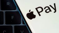 A smartphone with the Apple Pay logo is placed on a laptop in this illustration taken on July 14, 2021. File Photo / Reuters