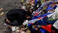 A man kneels at the Lion Statue of Kanjuruhan Stadium as he pays his condolences for the victims of a riot and stampede following a soccer match between Arema vs Persebaya Surabaya in Malang, East Java province, Indonesia, October 4, 2022, in this photo taken by Antara Foto. Antara Foto/Zabur Karuru/ via REUTERS