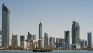 A fishing boat passes in front of the Kuwait City skyline on September 11, 2010.  File Photo / Reuters
