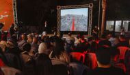 Palestinians watch the sixth edition of the Red Carpet Film Festival, at a newly innovated theatre in Gaza City, October 13, 2022. Reuters/Ibraheem Abu Mustafa