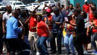 Workers at South Africa's state-owned logistics firm Transnet demonstrate for a second week outside the Port of Cape Town as they continue on a nationwide strike action that could paralyse ports and freight rail services in Cape Town, South Africa, October 17, 2022. (REUTERS/Esa Alexander)