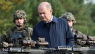 German Chancellor Olaf Scholz looks at weapons during a visit to a military base of the German army Bundeswehr in Bergen, Germany, on October 17, 2022. REUTERS/Fabian Bimmer