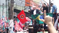 Former Brazil's President and current presidential candidate Luiz Inacio Lula da Silva and Sao Paulo Governor candidate Fernando Haddad greet supporters during a march in Sao Paulo, Brazil, October 17, 2022. (REUTERS/Carla Carniel)