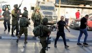 File Photo: Israeli soldiers outside a Palestinian shop in Huwara, West Bank, May 26, 2022. (REUTERS/Raneen Sawafta)