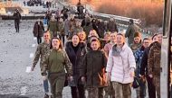Ukrainian prisoners of war (POWs) walk after a swap, amid Russia's attack on Ukraine, in an unknown location, Ukraine, on October 17, 2022. Head of Ukraine's Presidential Office Andriy Yermak via Telegram/Handout via REUTERS