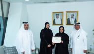 Minister of Social Development and Family H E Mariam bint Ali bin Nasser Al Misnad (second left) handing over the certificate of registration of the association to Dr. Maryam Abdul Rahman Al Nuaimi and Abdul Aziz Abdul Rahim Al Sayed. 