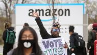 An Amazon Labour Union (ALU) organiser greets workers outside Amazon’s LDJ5 sortation center, as employees begin voting to unionise a second warehouse in the Staten Island borough of New York City on April 25, 2022.  File Photo / Reuters

