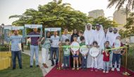 Officials with children and residents at the inauguration of a community garden at The Pearl Island. 