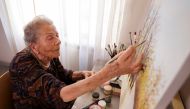Nada Rudan, a 100-year-old self-taught Bosnian painter, paints in her home, in Sarajevo, Bosnia and Herzegovina, October 20, 2022. REUTERS/Dado Ruvic