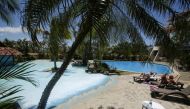 Tourists sunbathe near a pool in a hotel in Heredia, Costa Rica, on March 18, 2020.  File Photo / Reuters
