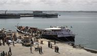 Workers stand at the sea port of the coastal town of Kismayu in southern Somalia in this November 12, 2013 file photo. File Photo / Reuters

