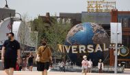Tourists walk near an entrance to the Universal Studios theme park as it reopens to the general public, following the coronavirus disease (COVID-19) outbreak in Beijing, China June 25, 2022. REUTERS/Tingshu Wang/File Photo

