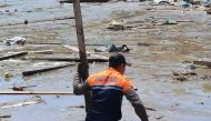 This handout photo taken on October 30, 2022 and released by the Philippine Coast Guard on October 31 shows a rescue worker using a makeshift pole as they conduct search operations in Datu Odin Sinsuat, Maguindanao province, after Tropical Storm Nalgae hit the region. Photo by Handout / Philippines Coast Guard (PCG) / AFP) / 