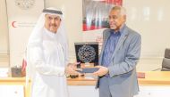 Dr. Abdel Wahab Al Affendi, President and Provost of Doha Institute, and Ali bin Hassan Al Hammadi, Secretary-General of QRCS, exchanging documents after signing the agreement yesterday.