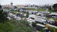 Supporters of Brazil's President Jair Bolsonaro, mainly truck drivers, block the Castello Branco highway during a protest over Bolsonaro's defeat in the presidential run-off election, in Barueri, Brazil, on November 1, 2022. REUTERS/Carla Carniel
