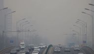 Cars move on a road during a day with polluted air, following the outbreak of the coronavirus disease (COVID-19), in Beijing, China February 13, 2021. REUTERS/Carlos Garcia Rawlins
