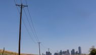 Utility poles lead to downtown Dallas during a heat advisory due to scorching weather in Dallas, Texas, U.S. July 12, 2022. REUTERS/Shelby Tauber
