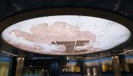 A person looks at a map of Piraeus that showcases the ancient irrigation system inside Piraeus subway station, near Athens, Greece, October 19, 2022. REUTERS/Louiza Vradi