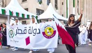 Children carry Algeria and Qatar flags during Algeria's 68th Anniversary of the Revolution day in Algiers on Tuesday. (QNA)