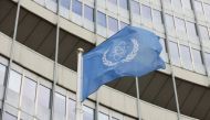 The flag of the International Atomic Energy Agency (IAEA) waves in front its headquarters in Vienna, Austria, May 23, 2021. (REUTERS/Leonhard Foeger)