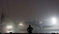 A security personnel stands near a damaged suspension bridge after it collapsed on Sunday, in Morbi town in the western state of Gujarat, India, November 1, 2022. REUTERS/Stringer/File Photo
