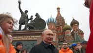 Russian President Vladimir Putin speaks with members of public associations, youth and volunteer organizations during a flower-laying ceremony at the monument to Kuzma Minin and Dmitry Pozharsky while marking Russia's Day of National Unity in Red Square in central Moscow, Russia, on November 4, 2022. (Sputnik/Mikhail Metzel/Pool via REUTERS)
