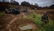 Ukrainian servicemen from the 127th brigade inspect destroyed Russian army's Armored Personal Carriers (APC) near the Ukrainian border with Russia in Kharkiv region, on November 5, 2022. (Photo by Dimitar DILKOFF / AFP)