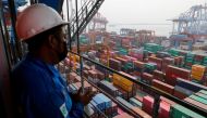 A technician stands on a crane at the Tanjung Priok port in Jakarta, Indonesia, August 3, 2022. REUTERS/Willy Kurniawan/File Photo